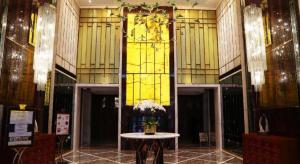 a room with a table and a yellow window at LIA! BEIJING HOTEL in Beijing