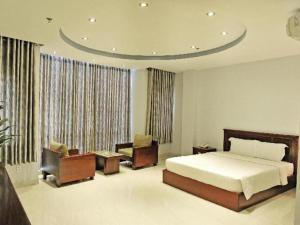 a bedroom with a bed and a couch and chairs at Phoenix Hotel Saigon in Ho Chi Minh City +46 photos