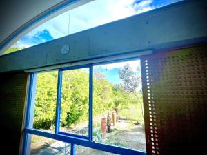 a window in a building with a view of a forest at スターハウス in Otsu