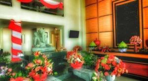 a room with flowers and a statue in a building at V Boutique Hotel @ Koh Pich in Phnom Penh