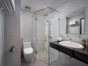 a bathroom with a toilet and a sink and a shower at Minerva Aparthotel Hanoi in Hanoi +33 photos