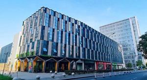 a large building in a city with a street at Musang Smart Hotel Changzhou in Changzhou