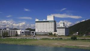 two large white buildings next to a body of water at Gifu Grand Hotel in Gifu