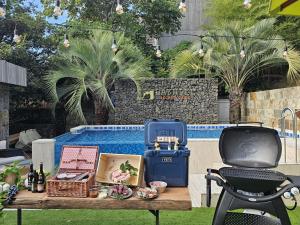 a picnic table with items on it next to a pool at Bayhill Pool & Villa in Seogwipo