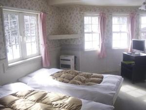 Postel nebo postele na pokoji v ubytování Hakuba Sun Valley Hotel