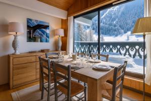 a dining room with a table and a large window at Beautiful apartment with superb view of Mont Blanc in Chamonix-Mont-Blanc