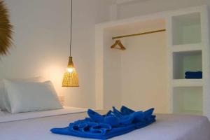 a blue towel sitting on a bed with a lamp at Lanta Secret House in Ko Lanta +18 photos