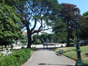 a park with a street light and a tree at Hôtel & Espace Bien-être La Maison du Lierre in Biarritz