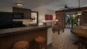 a hotel room with a kitchen and a living room at Disney's Animal Kingdom Villas - Jambo House in Orlando
