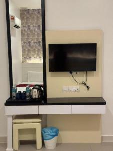 a television on a counter in a room at LF Hotel Tapah in Kelian Baharu