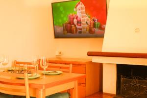 a dining room with a table and a fireplace at Apartment Di Lago Family by GardaDoma in Brenzone sul Garda