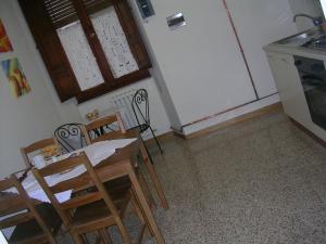 a kitchen with a table and chairs and a refrigerator at Ascoli Antica B&B in Ascoli Piceno +20 photos
