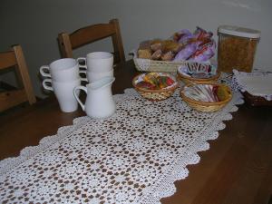 a table with a white table cloth with baskets of food at Ascoli Antica B&B in Ascoli Piceno