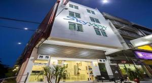 a building with a sign on the side of it at Skyview Hotel in Kampong Geliga