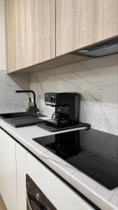 a kitchen with a stove top with a microwave at Light 2-кімн Нова стильна квартира на Київській in Ternopilʼ +29 photos