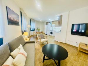a living room with a couch and a table at Apartamentos San Nicolas Jaca in Jaca