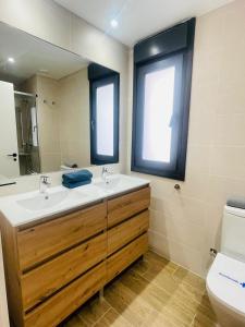 a bathroom with a sink and a toilet at Apartamentos San Nicolas Jaca in Jaca +59 photos