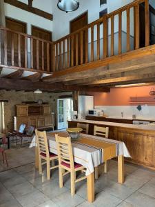 a kitchen with a table and chairs in a room at Gîtes OSTAL de Marcillac avec piscine - Petit Bois in Capelou
