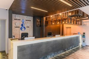 a lobby with a reception desk in a building at Johann Strauss Hotel in Bucharest