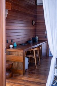 a kitchen with a wooden table in a room at Naya Lodge in Mitsamiouli