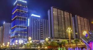 a group of tall buildings in a city at night at Echarm Hotel Guizhou Xingyi Jushan Avenue in Xingyin Wanfenglin Airport