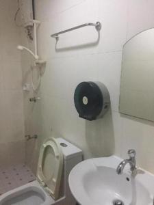 a small bathroom with a toilet and a sink at Jeamco Royal Hotel - Baybay in Baybay