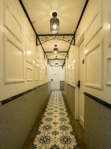 a long hallway with a tile floor in a building at Auberge Petit Hotel San Juan La Union in San Juan