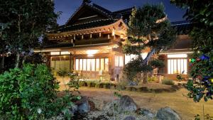 an asian style house with a garden at night at The Yata Kominka 谷田 in Shiroi