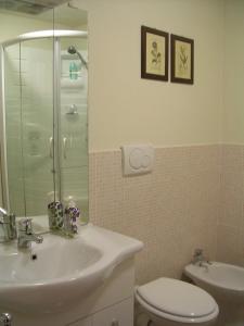 a bathroom with a sink and a toilet and a shower at Ascoli Antica B&B in Ascoli Piceno