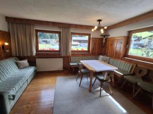a living room with a table and a couch at Plattnerhof Kaunertal in Kaunertal +34 photos