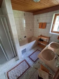 a bathroom with a tub and a sink at Plattnerhof Kaunertal in Kaunertal