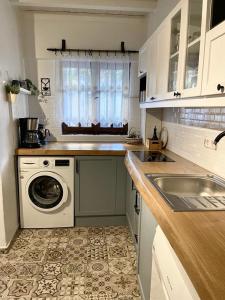a kitchen with a washing machine and a sink at Urbana - Ayvalık in Ayvalık