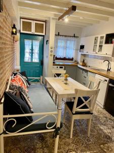 a small kitchen with a table and a table and chairs at Urbana - Ayvalık in Ayvalık +20 photos