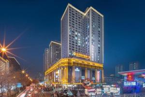 a tall building in a city at night at 7 Days Premium Xi'an Dayan Tower Xiaozhai Metro Station in Xi'an