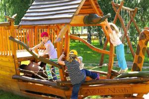 a group of children playing on a playground at Holiday home in Markkleeberg near a lake in Markkleeberg