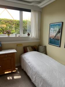 a bedroom with a bed and a window at Lises bed and breakfast in Svendborg