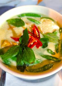 a bowl of soup with greens and peppers in it at Ta Dang Bay - Bungalow in Koh Chang Ranong
