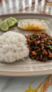 a plate of food with rice and vegetables on it at Ta Dang Bay - Bungalow in Koh Chang Ranong +20 photos