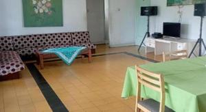 a living room with a couch and a table and a camera at SURGA DIRGA RESORT in Puncak +44 photos