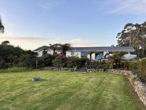 a house with a yard in front of it at Hokitika - Blue Spur Bed and Breakfast in Hokitika