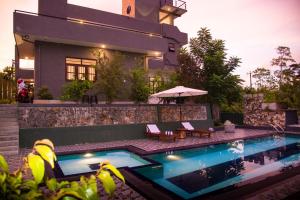 a house with a swimming pool in front of a house at Cinnamon Forest Villa - Private Luxury Villa in Hikkaduwa in Hikkaduwa