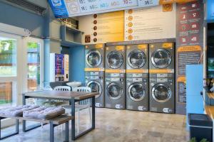 a bunch of washing machines in a laundry room at Nora Bukit Hotel in Ban Sam Kong
