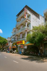 a large white building on the side of a street at Ánh Sao Hotel HCM in Ho Chi Minh City