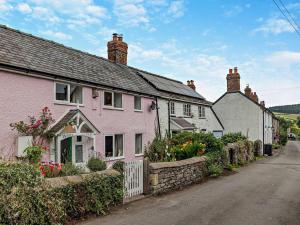 a couple of pink houses on a street at 2 Bed in Clun 83166 in Clun