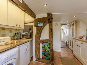 a kitchen with an archway in the middle of it at 1 bed in Sedlescombe 83845 in Sedlescombe +6 photos