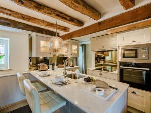 a kitchen with a large island with chairs in it at 1 bed in Cartmel 89364 in Cartmel