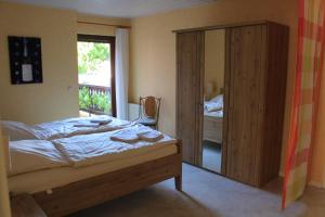 a bedroom with a bed and a sliding glass door at Weingut Gorges-Reinhard in Wintrich +21 photos