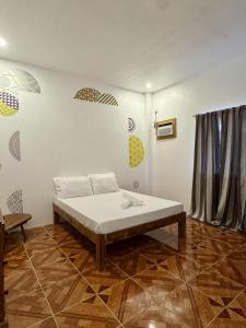 un dormitorio con una cama en una habitación en Puerto Paraiso Hostel, en Puerto Princesa 19 fotos más