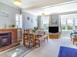 a living room with a table and a fireplace at 3 bed property in Overstrand KT178 in Overstrand