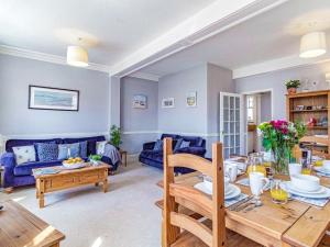 a living room with a table and a blue couch at 3 bed property in Overstrand KT178 in Overstrand